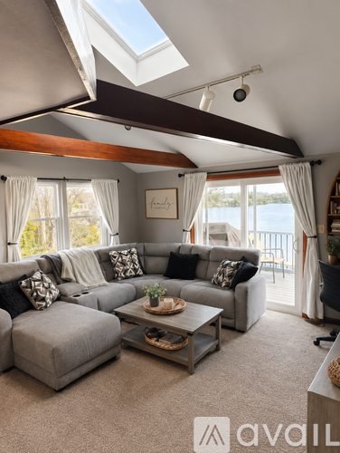 A living room with a grey couch and a coffee table.