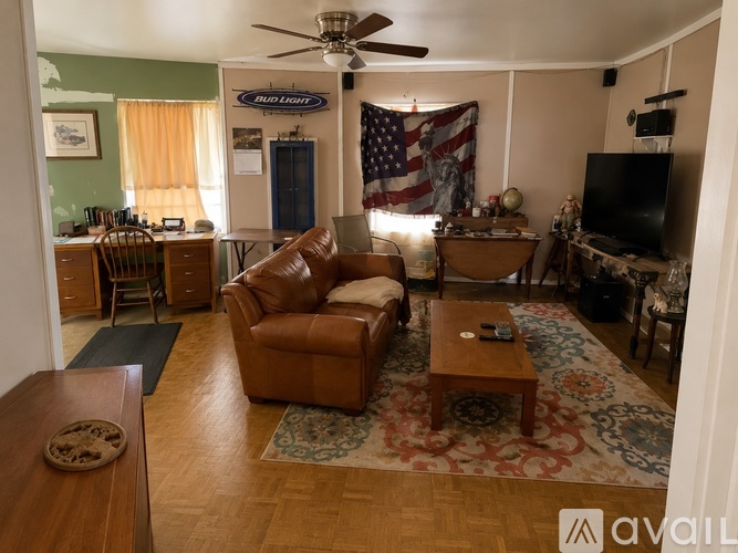 A living room with a Bud Light sign on the wall.