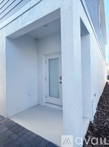 A white door is in a white building.