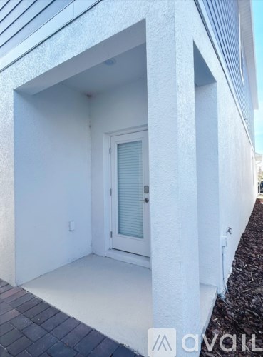 A white door is in a white building.