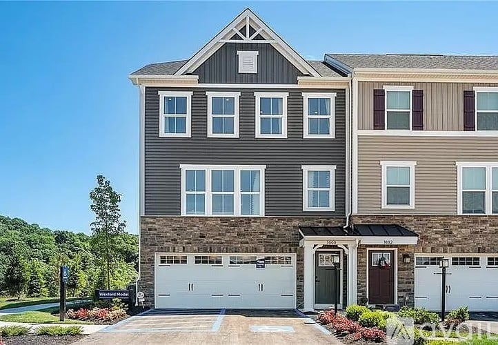 A two-story house with a garage on the ground floor.