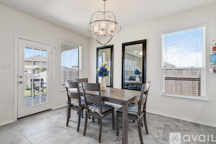 A dining room with a table set for four.
