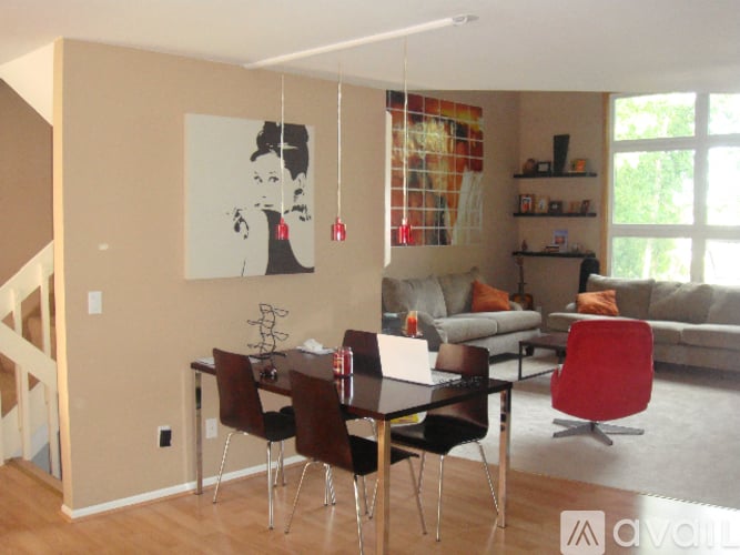 A dining room with a table and chairs.