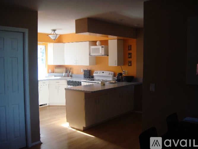 A kitchen with a white counter and cabinets.