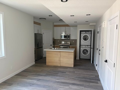 A kitchen with a washer and dryer built in.