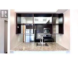 A kitchen with granite countertops and stainless steel appliances.