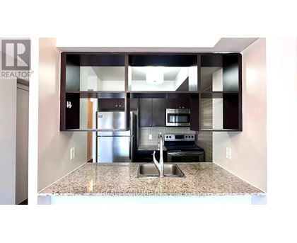 A kitchen with granite countertops and stainless steel appliances.