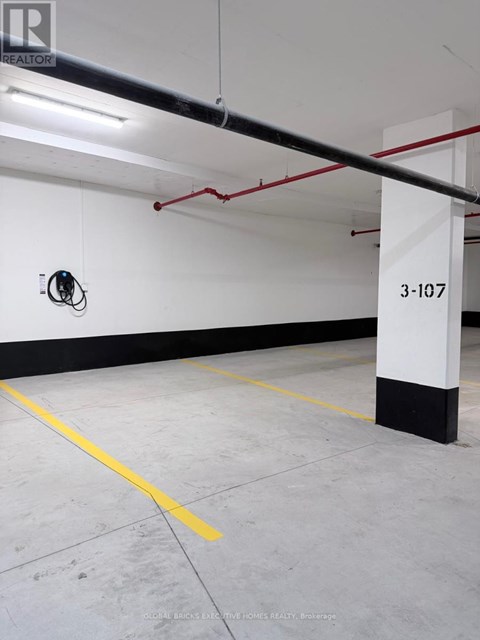 A parking garage with the number 3-107 on the wall.