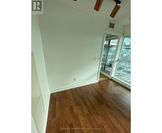 A room with wooden floors and white walls.