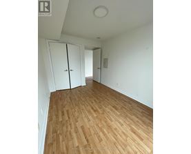 A room with wooden flooring and white walls.