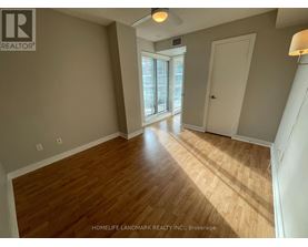 A room with wooden flooring and a sliding glass door.