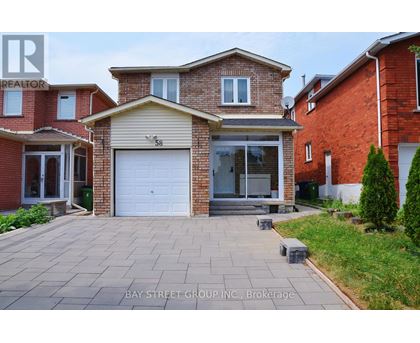 A house with a garage and a driveway in front of it.