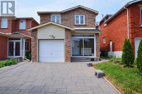 A house with a garage and a driveway in front of it.