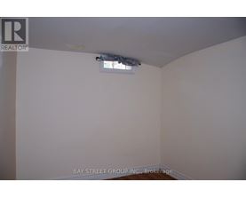 A room with a brokerage logo on the wall.