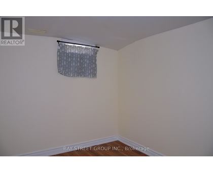 A room with a window covered by a curtain.