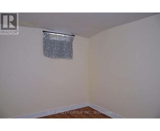 A room with a window covered by a curtain.