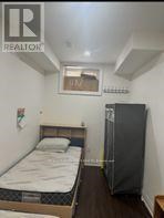A bedroom with a bed, wardrobe and window.