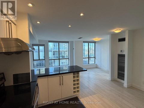 A kitchen with a black counter top and white cabinets.