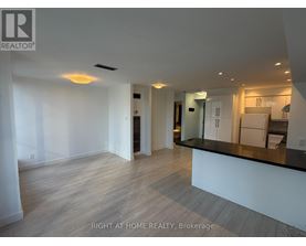 A spacious, well-lit kitchen area with a bar counter and modern appliances.
