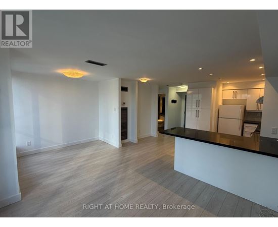 A spacious, well-lit kitchen area with a bar counter and modern appliances.
