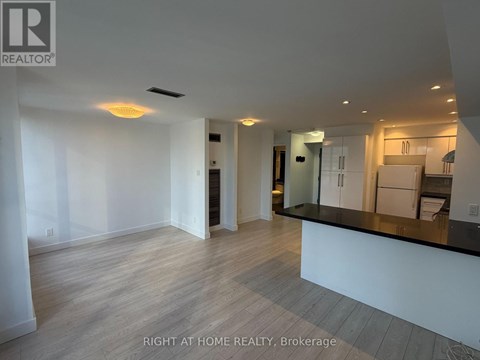 A spacious, well-lit kitchen area with a bar counter and modern appliances.
