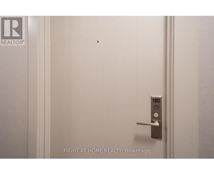 A door with a handle and a lock with the number 1802 on it.