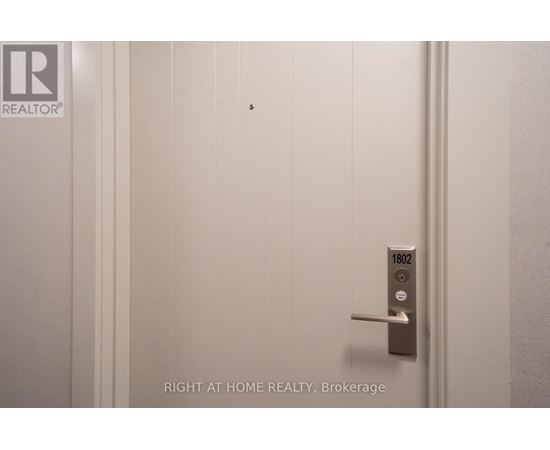 A door with a handle and a lock with the number 1802 on it.