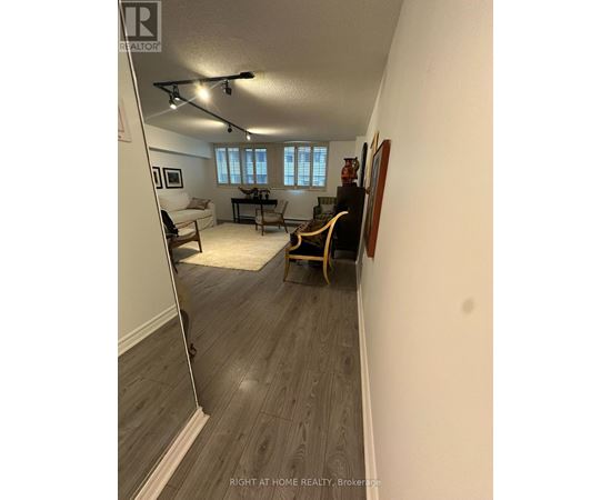 A living room with a couch, chair, and a piano.