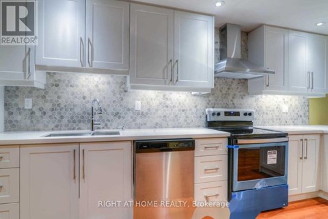 A kitchen with a stove top oven and a dishwasher.