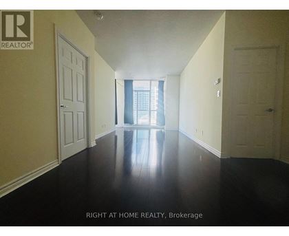 A hallway with a door on the left and right and a window in the middle.