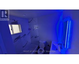 A bathroom with a blue light and a window.
