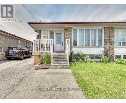 A house with a car parked in front of it.