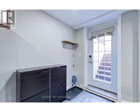 A room with a white door and a wooden shelf above it.