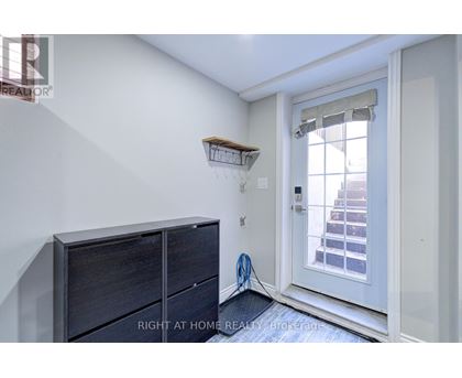 A room with a white door and a wooden shelf above it.