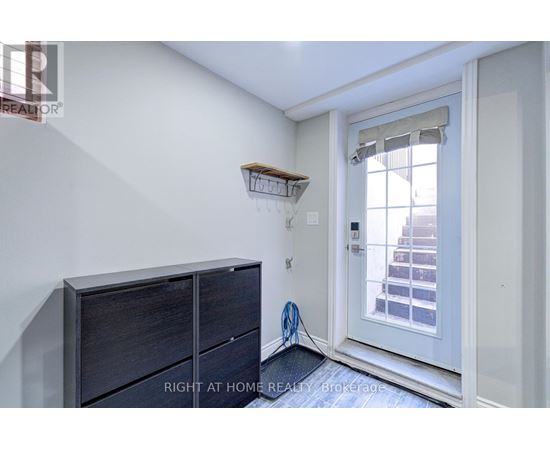 A room with a white door and a wooden shelf above it.