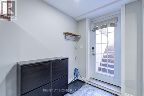 A room with a white door and a wooden shelf above it.