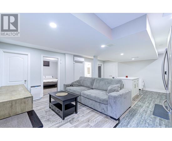 A living room with a grey couch and a black coffee table.