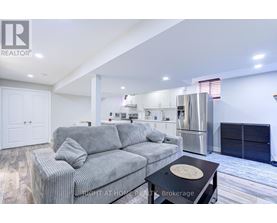 A modern living room with a grey sofa and a black coffee table.