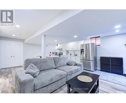 A modern living room with a grey sofa and a black coffee table.