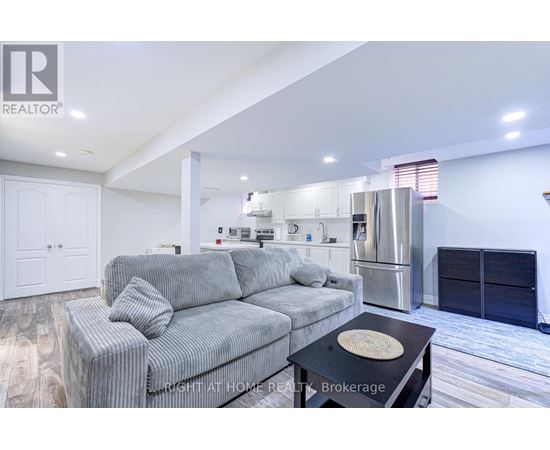 A modern living room with a grey sofa and a black coffee table.