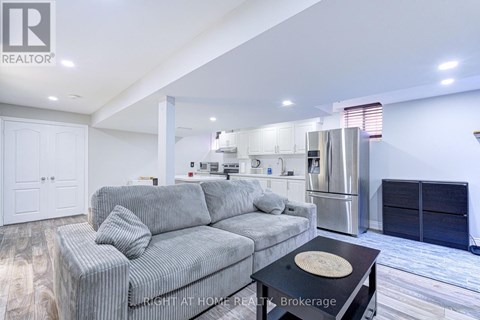 A modern living room with a grey sofa and a black coffee table.