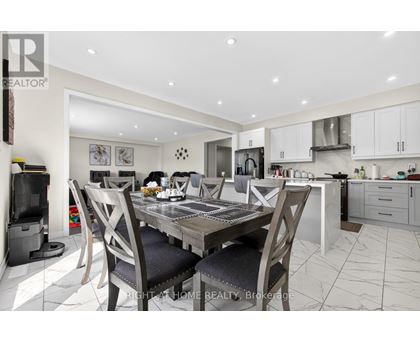A modern kitchen with a dining table set for four.