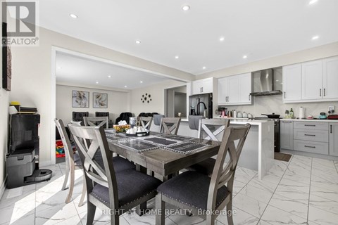 A modern kitchen with a dining table set for four.