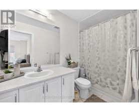 A bathroom with a sink, toilet, and shower.