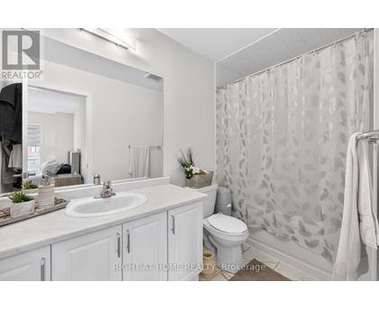 A bathroom with a sink, toilet, and shower.