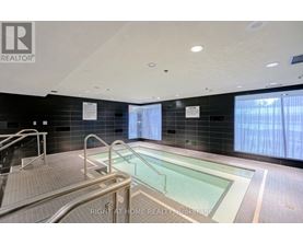 A swimming pool inside a building with a REALTOR® logo.