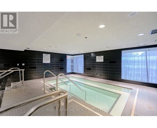 A swimming pool inside a building with a REALTOR® logo.