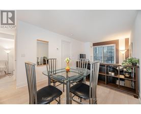 A dining room with a glass table and chairs.