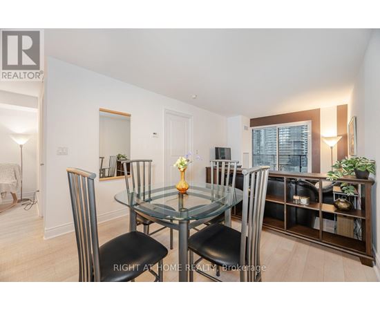 A dining room with a glass table and chairs.