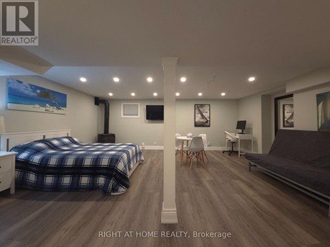 A bedroom with two beds and a couch.